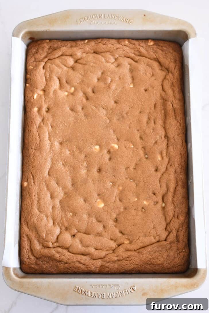 Metal 9x13-inch pan filled with freshly baked gingerbread blondie bars, golden brown and perfectly set.