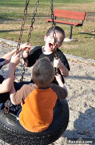 Three Favorite Snapshots from My Saturday 2 A person pushing a tire swing with two children enjoying the ride, embodying joyful family moments.