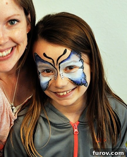 Three Favorite Snapshots from My Saturday 3 A child with a beautiful butterfly face paint design, showcasing the fun and creativity of face painting.