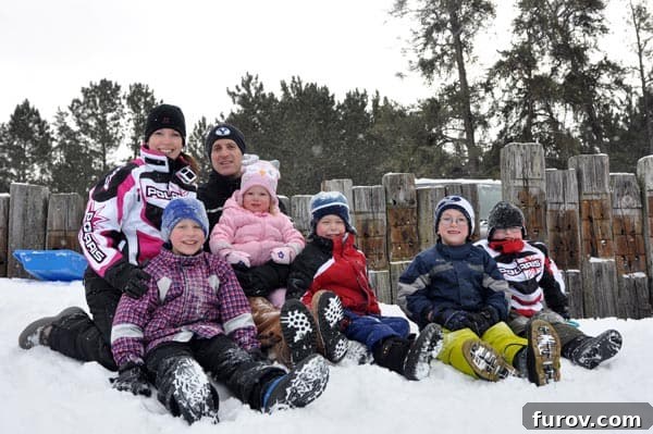 Sizzling Saturday Views 3 a family dressed in snow gear sitting in the snow
