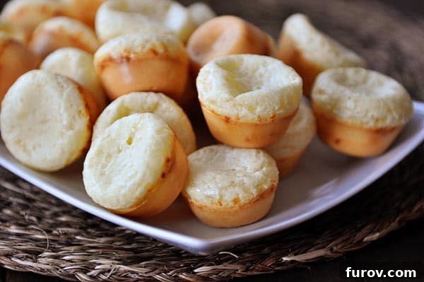Simple Cheesy Brazilian Pao de Queijo 4 A white platter full of mini Brazilian cheese breads.