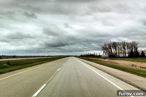 Saturday Survival: Mastering Summer Break 7 A wide, empty highway stretches endlessly into the horizon under a vast sky, symbolizing the freedom, adventure, and open possibilities of a summer road trip.