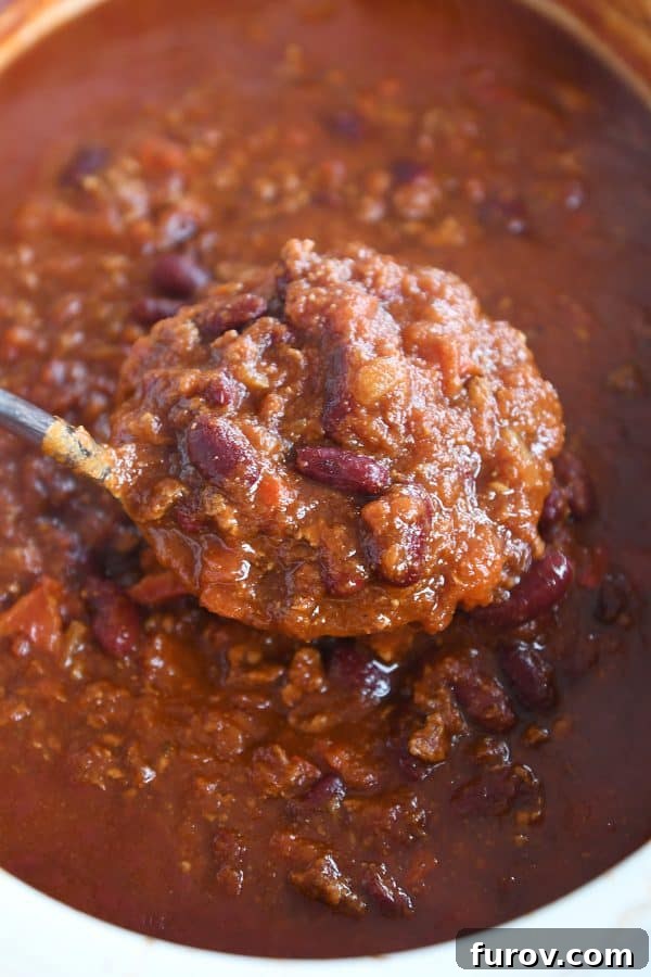 Slow-Simmered Comfort Chili 2 Ladle of classic slow cooker chili.