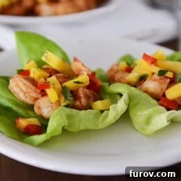 A close-up shot of two delicious shrimp and mango lettuce wraps.