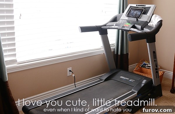 A woman on a treadmill, focusing intently on her run, embodying dedication to her fitness goals.