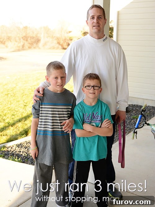 A family of runners, including a father and his sons, smiling after a successful outdoor run, showcasing family fitness and motivation.