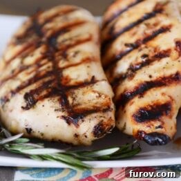 Close-up of a grilled chicken breast, showing its delicious texture and marinade, perfect for a recipe card image.