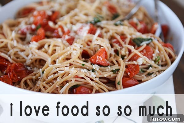 A hearty bowl of perfectly cooked spaghetti noodles, generously topped with fresh diced tomatoes and a sprinkle of parmesan cheese.
