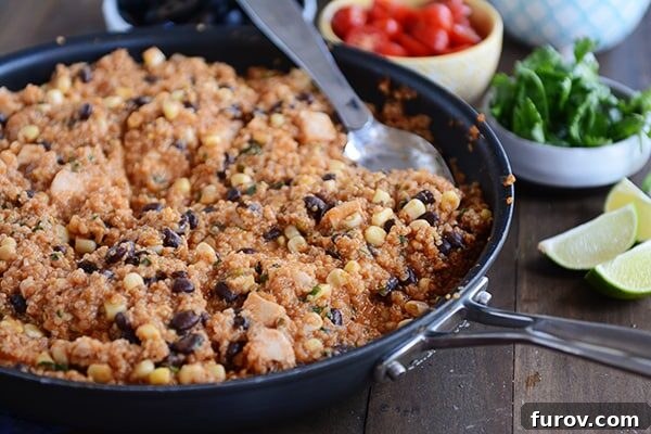 Effortless One-Pan Quinoa Enchiladas 4 A vibrant skillet brimming with a hearty quinoa chicken enchilada and black bean meal, ready to be served.