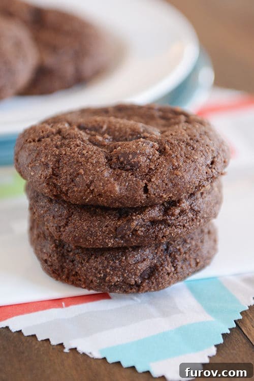Decadent Greek Yogurt Double Chocolate Cookies 3 A beautifully arranged stack of double chocolate Greek yogurt cookies on a colorful patterned napkin, showcasing their tempting texture and chocolate chips.