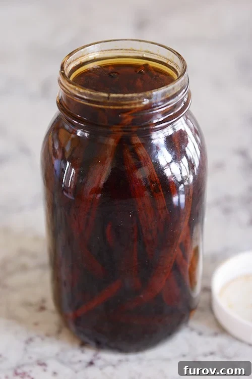 Vanilla beans soaking in a mason jar.