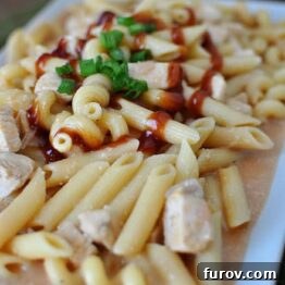 Smoky BBQ Chicken Pasta 3 Delicious BBQ Chicken Pasta in a skillet, ready to serve.