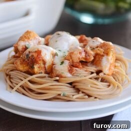 A dish of pesto and marinara mozzarella chicken bake, with a side of pasta.