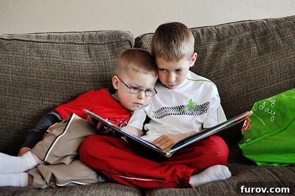 Unleash Imagination: Our Favorite Summer Reads for Kids 3 Two young boys sharing a moment, reading together on a cozy couch.