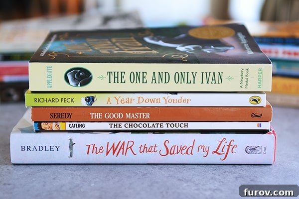 Unleash Imagination: Our Favorite Summer Reads for Kids 9 A modest stack of books sitting on a kitchen counter, ready for a young reader.
