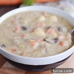 A bowl of creamy Russian potato and mushroom leek soup ready to be served.