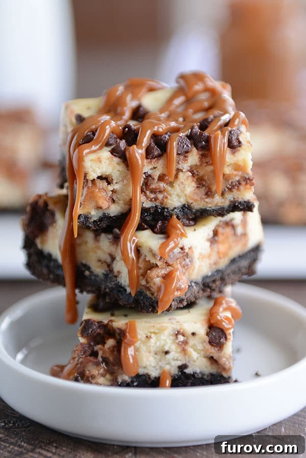 Stacked caramel cheesecake Oreo cheesecake bars in a white ramekin, showcasing the rich layers of chocolate crust, creamy cheesecake, and golden caramel topping.