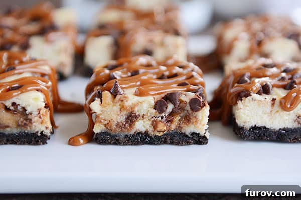Caramel drizzled cheesecake cookie bars, beautifully presented with a homemade touch on a white countertop, inviting you to taste.