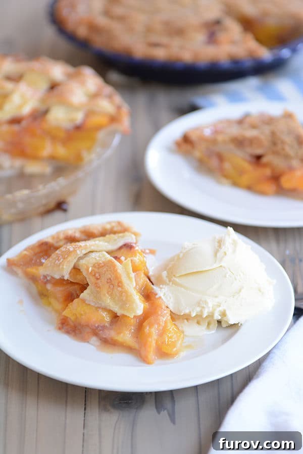 Juicy Fresh Peach Pie with Lattice or Crumb Topping 7 A elegant serving of peach pie with ice cream, set against a backdrop of freshly baked pies.