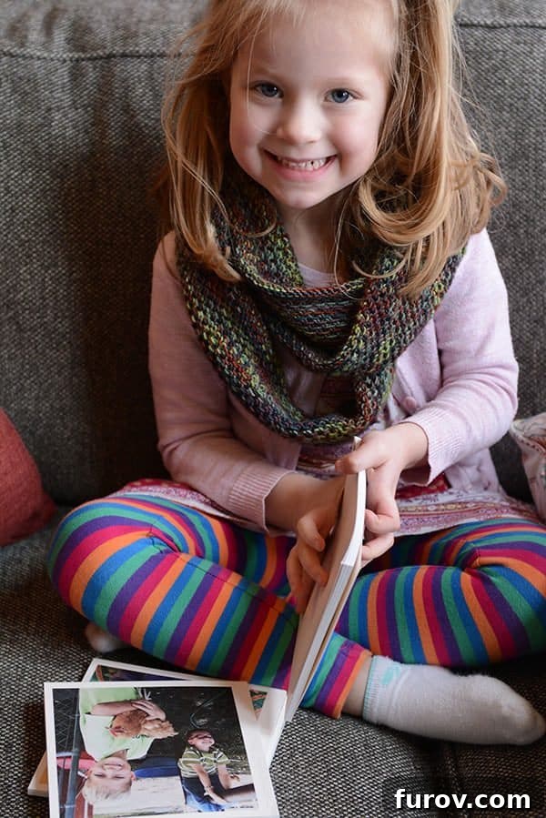 A little girl looking at books on a couch, enjoying quiet time or an 'Extra' activity.