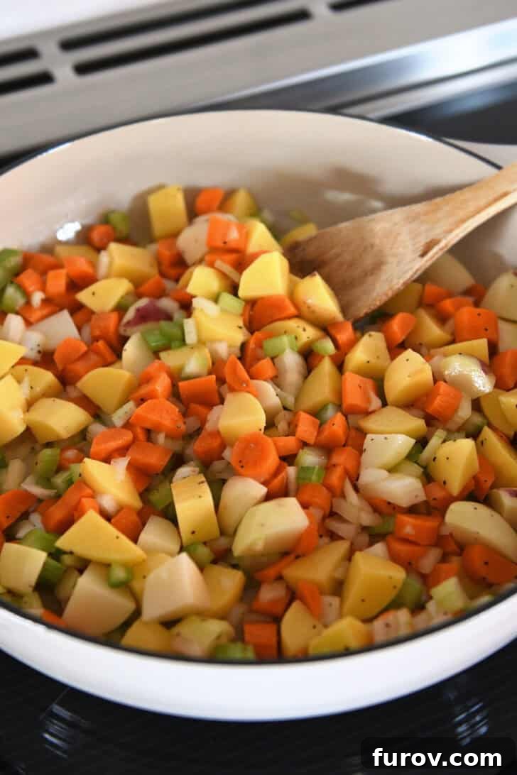 The Perfect Chicken or Turkey Pot Pie 3 Cast iron pan filled with carrots, potatoes, celery, or onions.