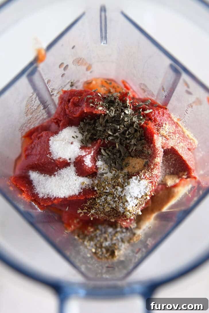 Blender with tomato paste, basil, oregano, salt and sugar.