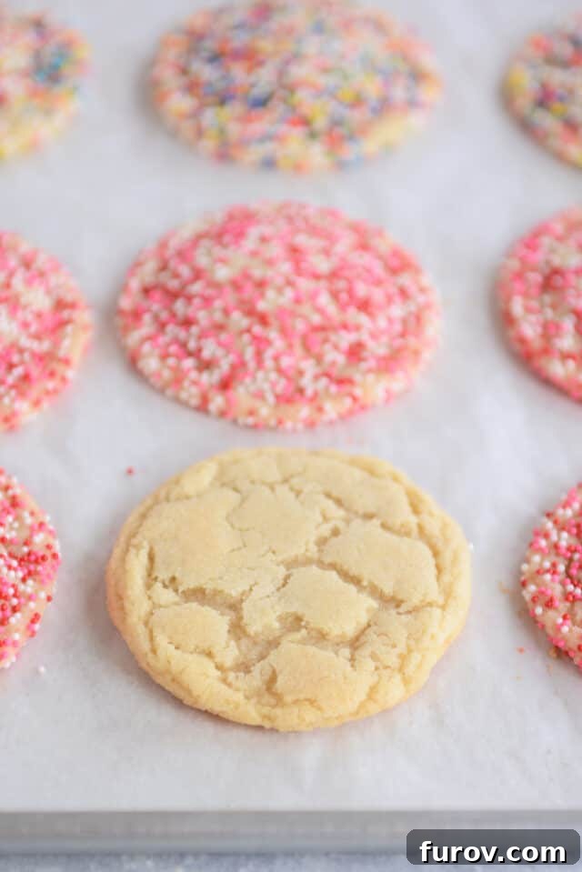 Effortless Soft and Chewy Drop Sugar Cookies 2 Freshly baked soft and chewy drop sugar cookies cooling on a baking sheet, ready to be enjoyed.