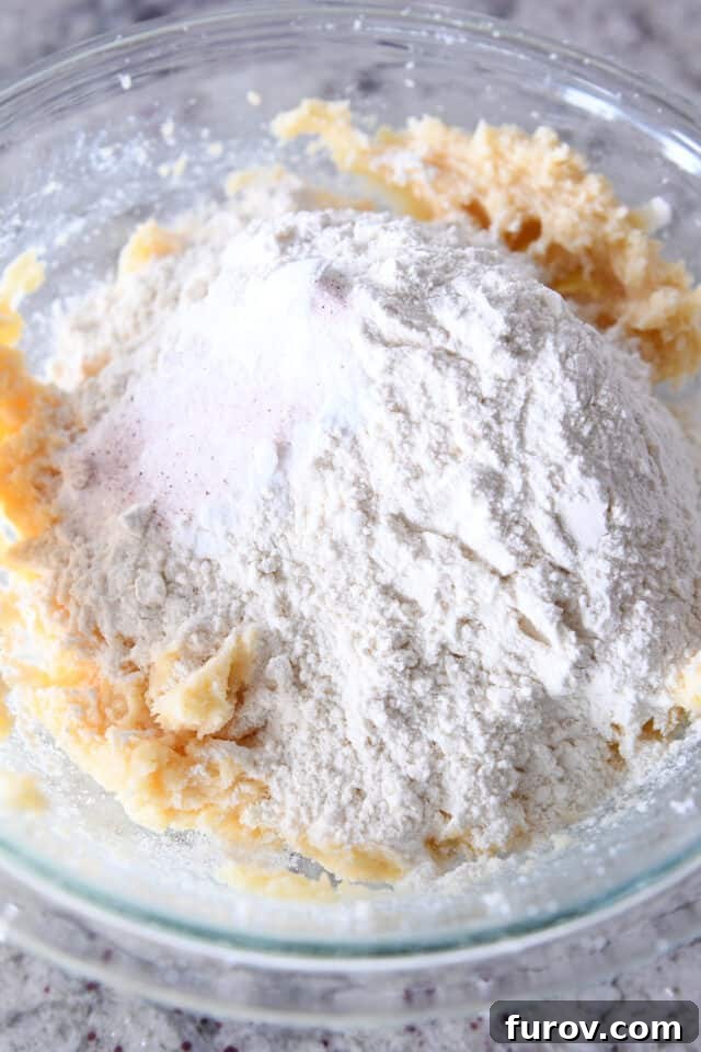Effortless Soft and Chewy Drop Sugar Cookies 3 Glass bowl filled with soft sugar cookie dough, ready for baking.