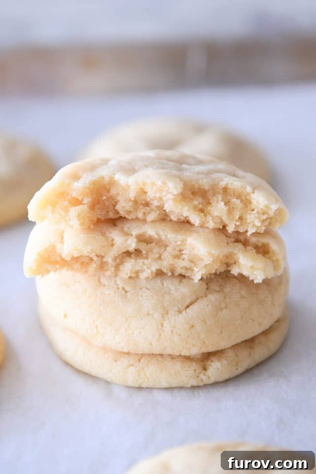 Effortless Soft and Chewy Drop Sugar Cookies 6 Comparison of two stacked sugar cookies, demonstrating the difference in thickness when adjusting flour content.