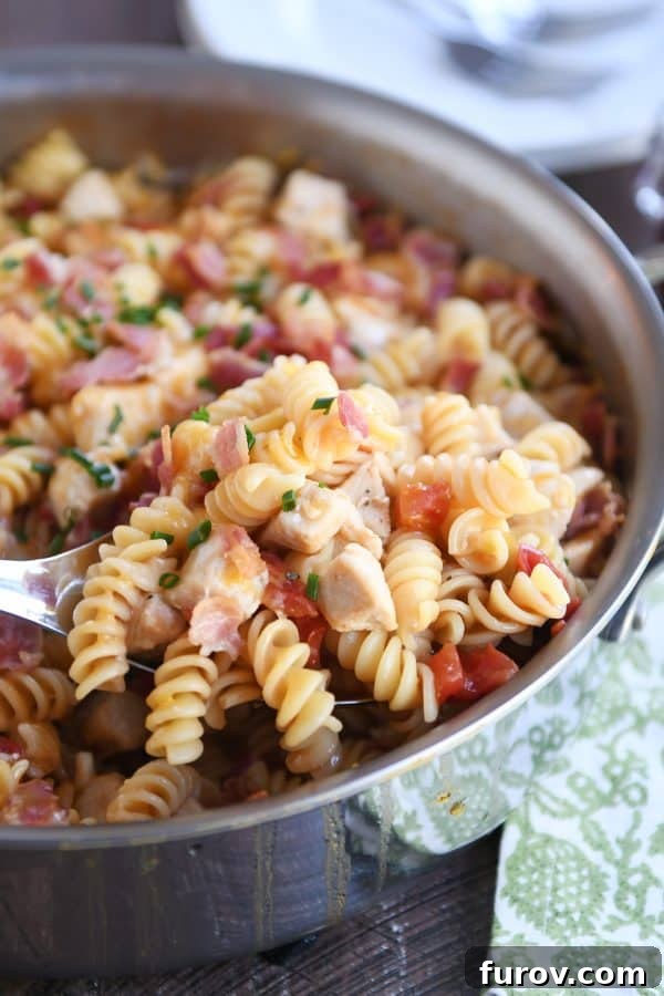 The Monterey BBQ chicken pasta simmering in a deep skillet.