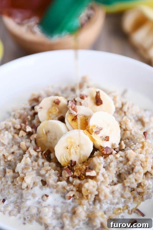 Comforting Instant Pot Banana Bread Steel Cut Oats 5 Honey being drizzled over bowl of Instant Pot banana bread steel cut oats.