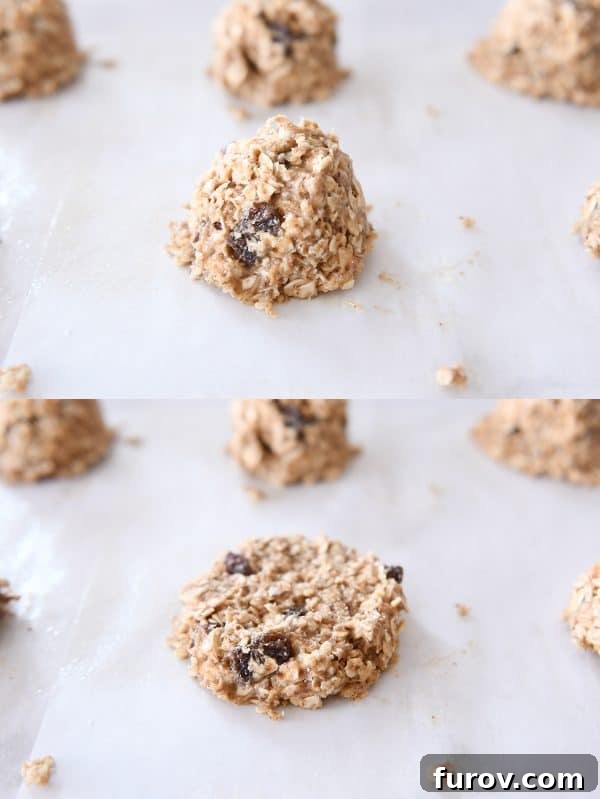 Oat cookie dough balls neatly arranged on a baking sheet, with one cookie expertly flattened into a disc shape, ready for baking.