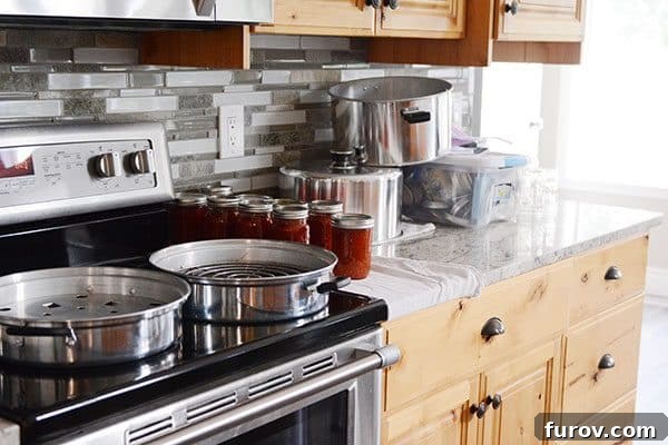 The Essential Home Canning Collection My Best Books Recipes and Resources 4 Several jars of small batch canned goods, emphasizing simplicity and accessibility.
