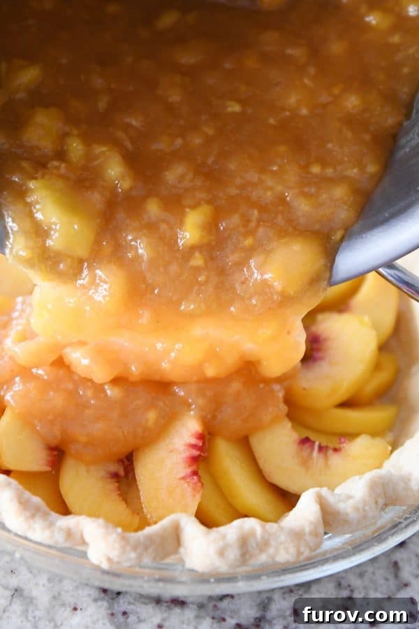 Pouring peach pie filling into pie.