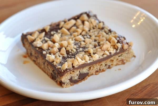 Chocolate toffee shortbread bar on a white plate.