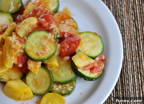 A beautifully arranged white plate of sautéed zucchini and yellow squash slices, topped with a rustic tomato sauce and fresh herbs, ready to be served as a delightful summer side.
