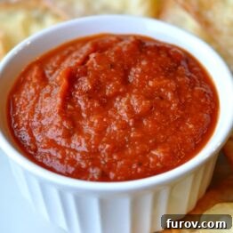 Close-up of classic marinara sauce in a white ramekin, ready to serve.