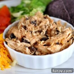 Pineapple Salsa Chicken in a slow cooker, ready to be served with vibrant toppings.