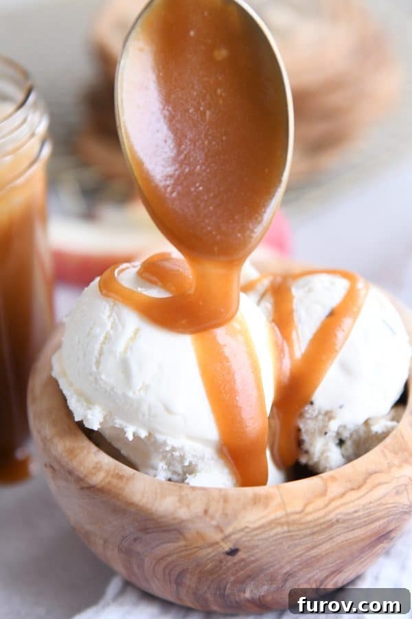 From Scratch Golden Caramel Bliss 2 Drizzling homemade caramel sauce on ice cream, showcasing its rich, flowing consistency.