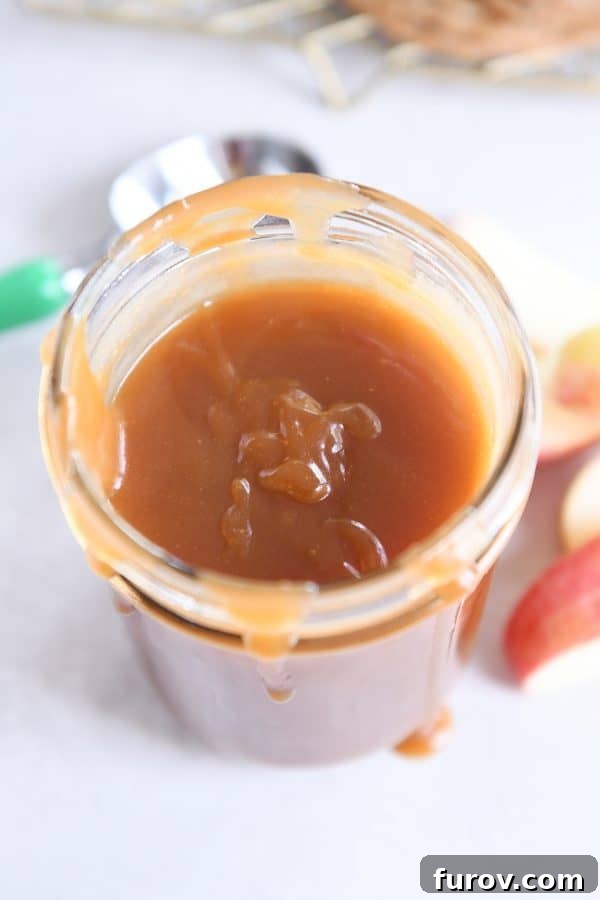 From Scratch Golden Caramel Bliss 3 Homemade caramel sauce in a clear glass jar, ready for storage or serving.