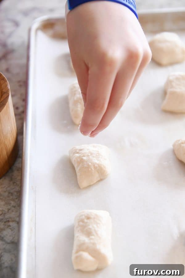 Irresistible Homemade Pretzel Bites 15 Sprinkling easy homemade soft pretzel bites with salt before baking.