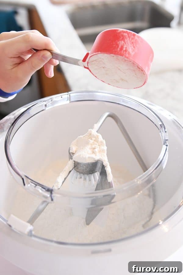 Irresistible Homemade Pretzel Bites 6 Adding flour to bosch mixer for pretzel dough.