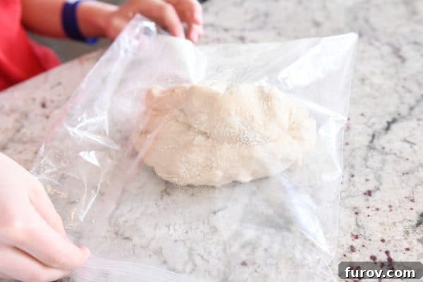 Irresistible Homemade Pretzel Bites 10 Putting pretzel bite dough in greased bag to rise.