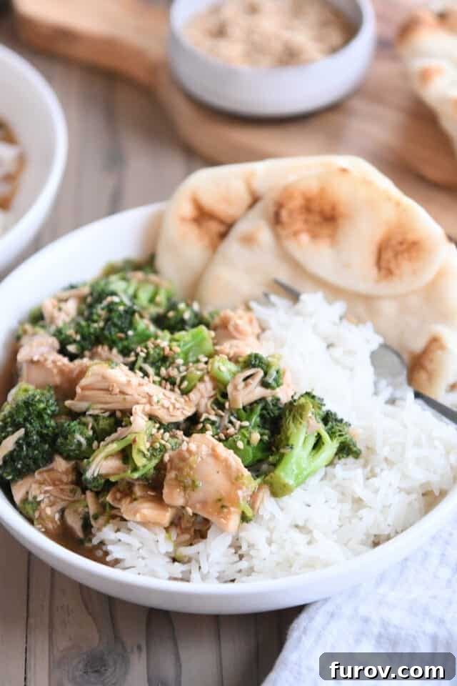Naan bread in white bowl with rice, chicken, broccoli and brown sauce. A delicious, quick, and easy Chinese chicken and broccoli recipe.