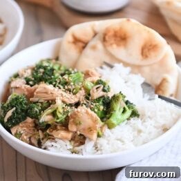 Naan bread in white bowl with rice, chicken, broccoli and brown sauce