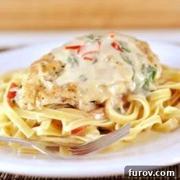 Homemade Tuscan Garlic Chicken served on a white plate with pasta.