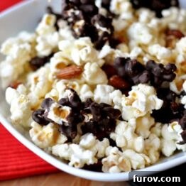 A white bowl full of chocolate-dipped kettle corn.