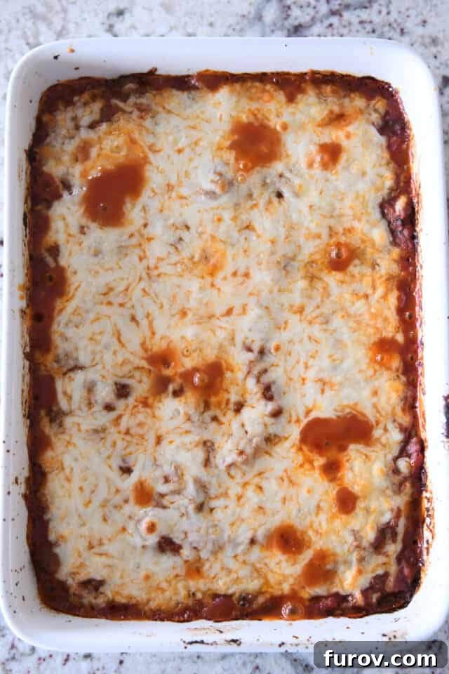 Golden Cheesy Zucchini Spaghetti Bake 5 Baked cheesy zucchini casserole in white dish.