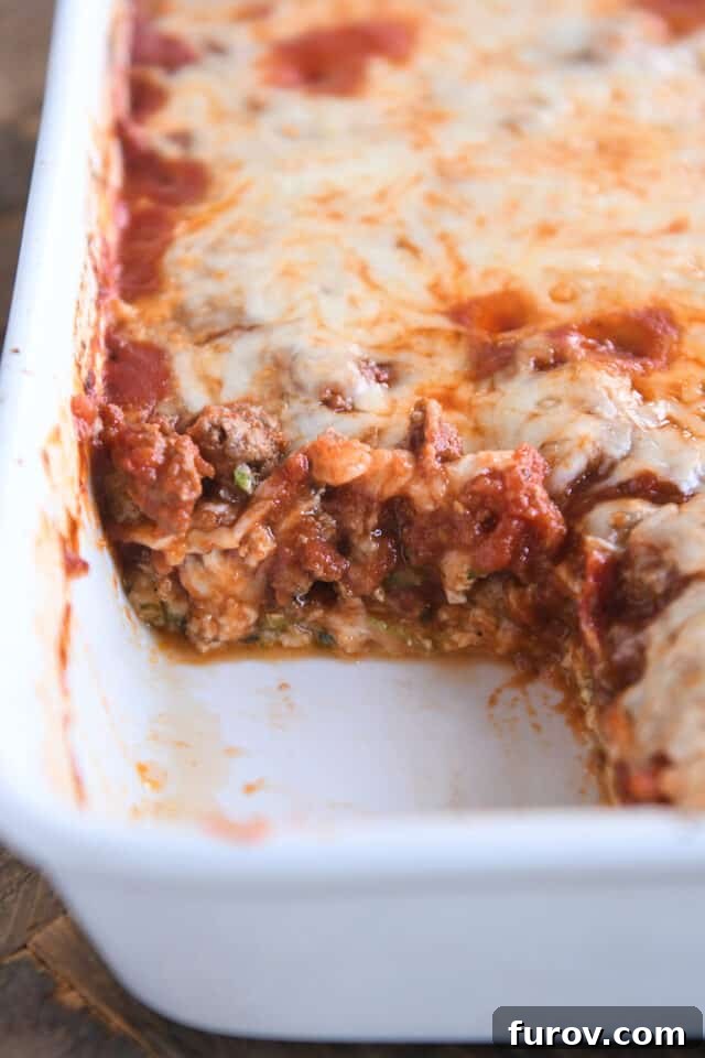 Golden Cheesy Zucchini Spaghetti Bake 6 Cheesy zucchini spaghetti casserole in white baking dish with serving taken out.