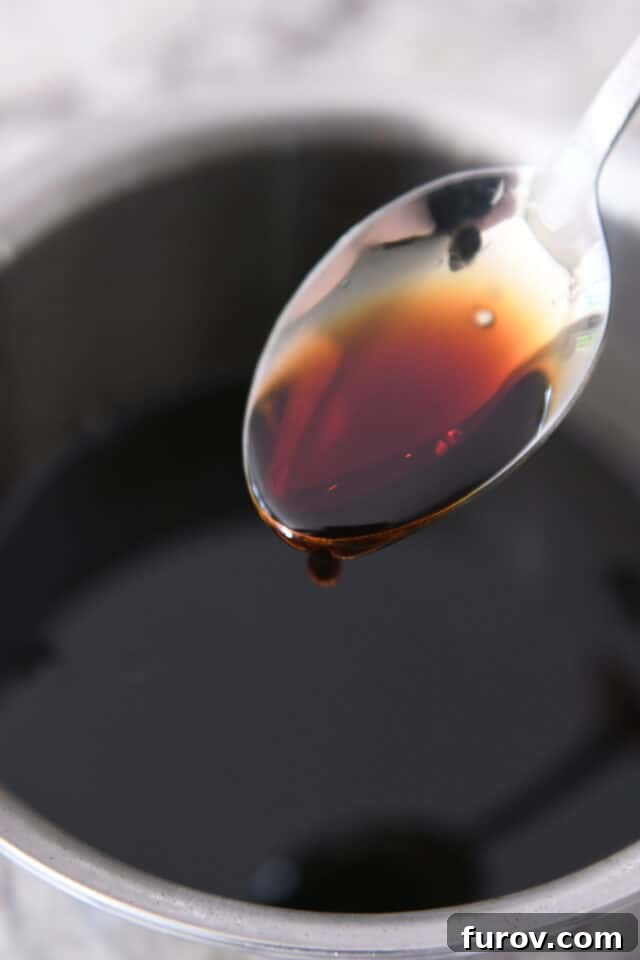 Grilled Chicken with Our Signature Teriyaki Glaze 3 Spoon with drip of teriyaki sauce.